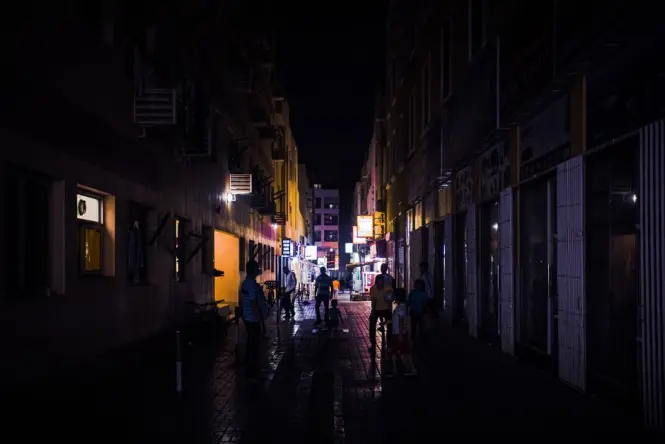 People gathering outside a crowded local bar in Palermo