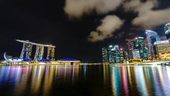 Marina Bay Sands skyline lit up at blue hour near Merlion Park