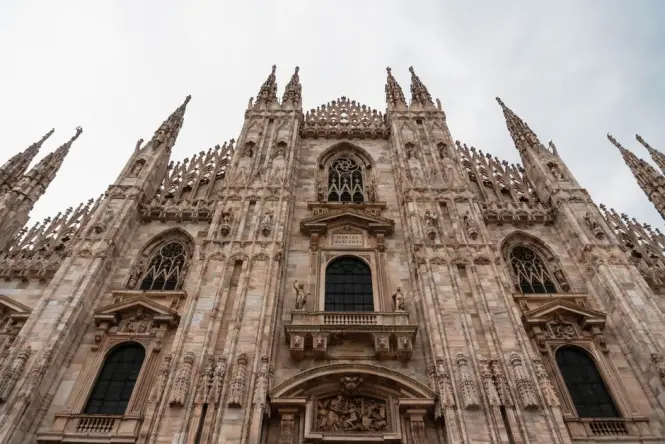 Visitors queuing outside the historic entrance of Milan Cathedral
