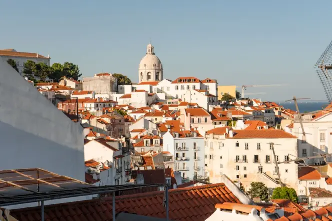 Alfama rooftops at sunrise from a Lisbon miradouro