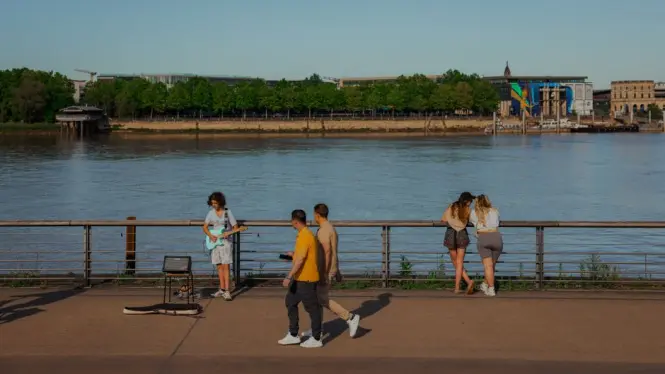 People walking along the Garonne quays in Bordeaux