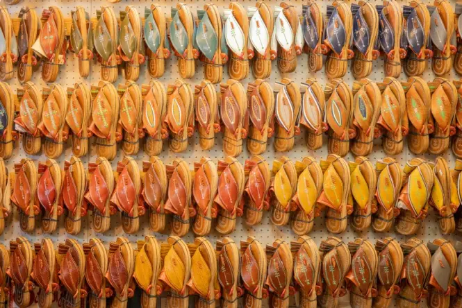 Traditional handmade Greek leather sandals hanging outside a workshop in Athens.