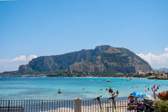 Sunbeds and umbrellas packed on Mondello Beach