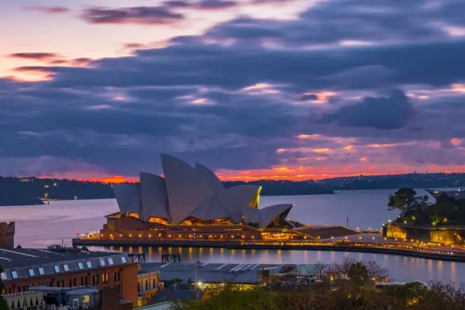 Sunrise light on the Sydney Opera House sails viewed from the harbour headland