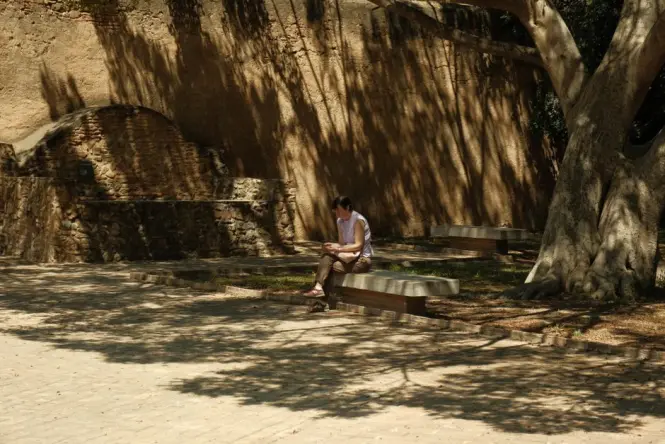 People sitting on curved benches in the MuseumsQuartier courtyard in summer