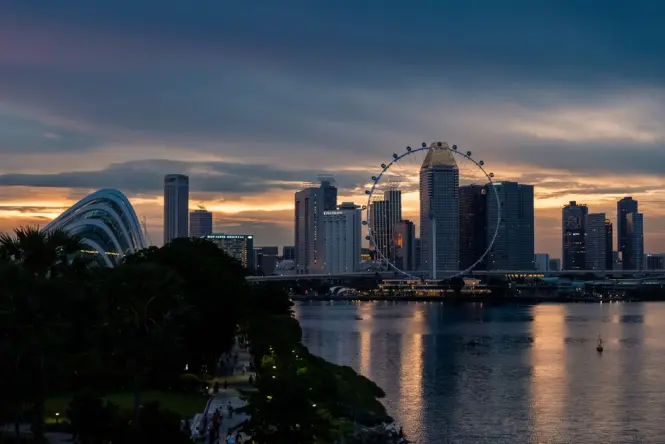 Rooftop dining terrace with sunset view over the Singapore skyline
