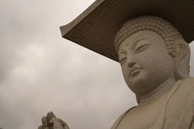 An ancient Korean bronze Pensive Bodhisattva statue sitting in contemplation