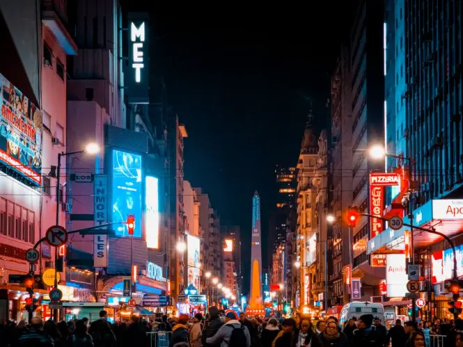 Illuminated theater marquees along Avenida Corrientes near the Obelisk