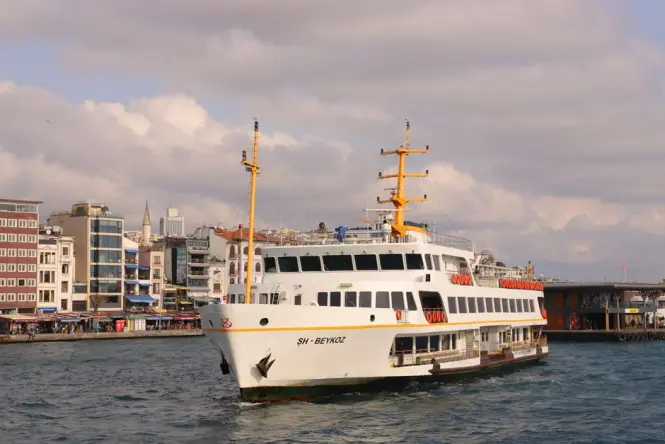 Ferry crossing the Bosphorus near the Ortaköy waterfront pier