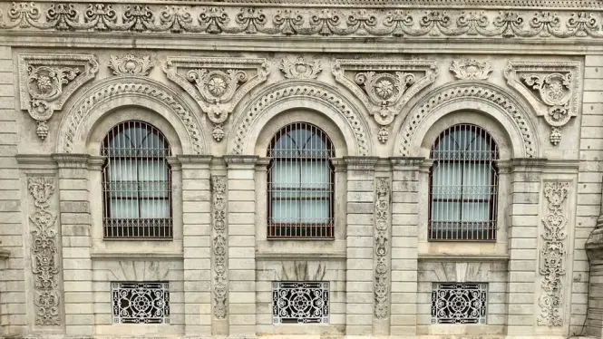 Ornate carved stone window detail on Ortaköy Mosque's Baroque facade