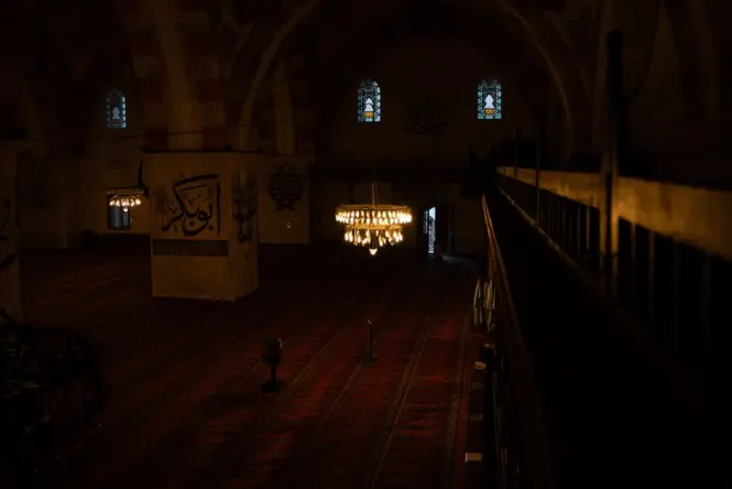 Interior prayer hall of Ortaköy Mosque with chandelier and arched windows