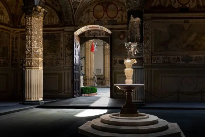 The historic stone arches and courtyard stairs inside the Norman Palace in Palermo