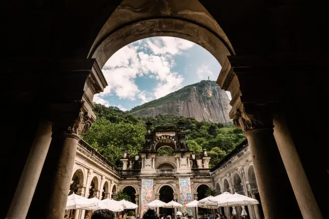 Arched courtyard inside the Parque Lage mansion with visitors walking through