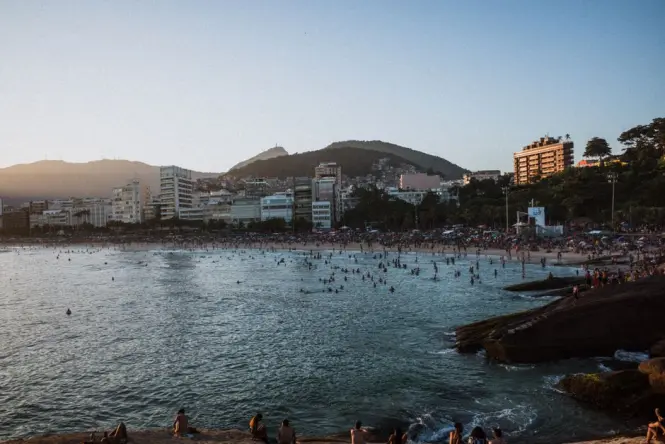 Visitors gathered on Pedra do Arpoador rock waiting for sunset