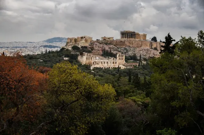 Stone path through pine forest near ancient ruins on Philopappos Hill