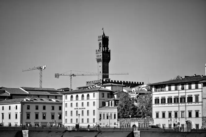 The tall stone tower of Palazzo Vecchio looking up from the square