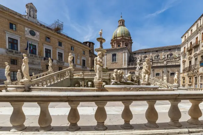 Piazza Pretoria illuminated at night under spotlighting without crowds