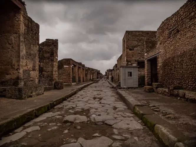 Uneven basalt stone road in Pompeii on a sunny day