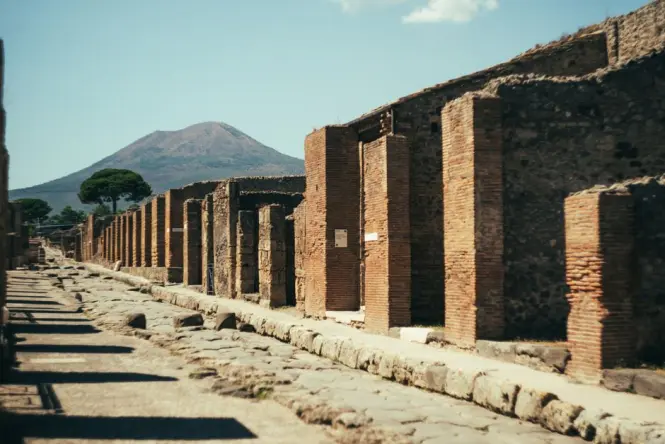 Ancient Roman columns in Pompeii under a blue sky