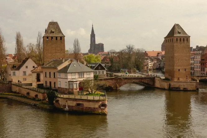 Ponts Couverts towers beside the canal