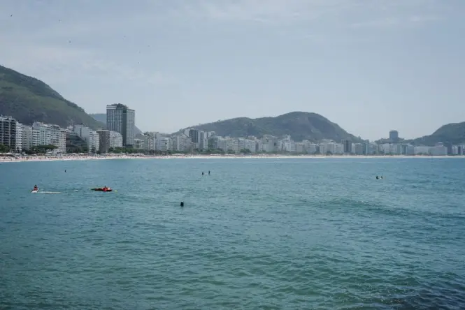 Swimmers wading in the calm, sheltered water of Praia Vermelha