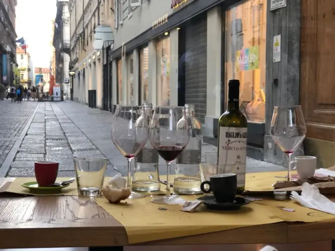 Outdoor dining tables in a quiet pedestrian square in Turin