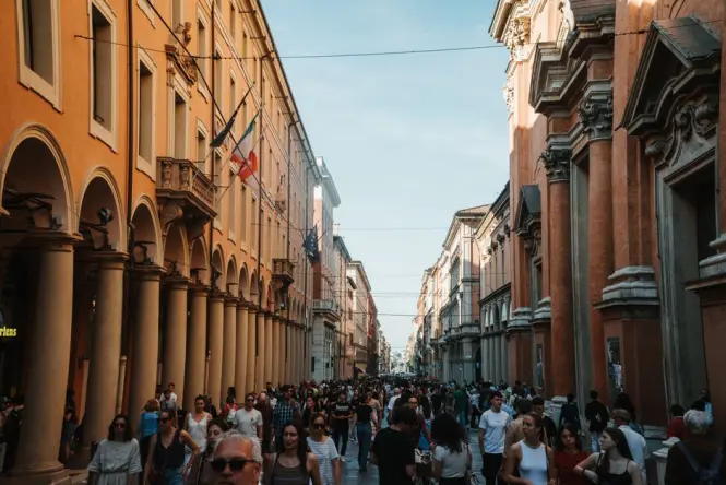 A narrow alley in the Quadrilatero market area with shoppers and historic storefronts