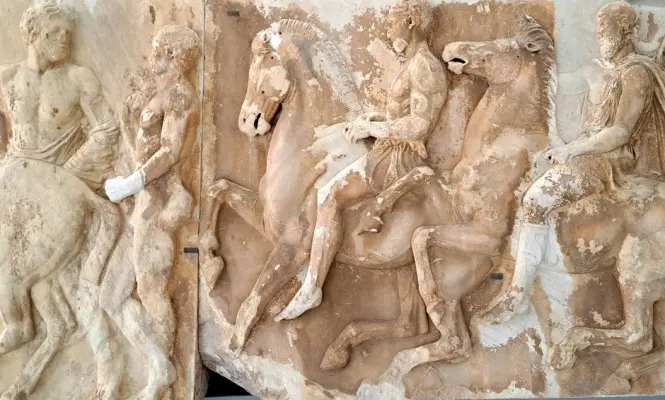 Detailed relief carving of a wind figure on the Tower of the Winds