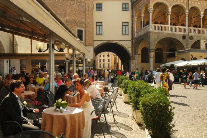 Cafe seating in the historic triangular piazza outside Santo Stefano