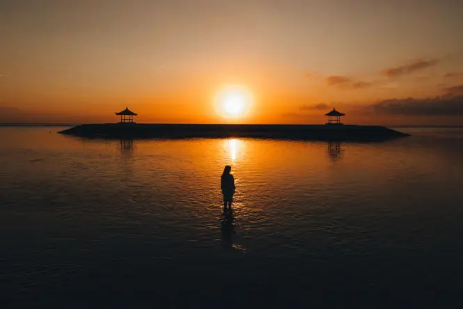 Sunrise over Sanur Beach with traditional fishing boats