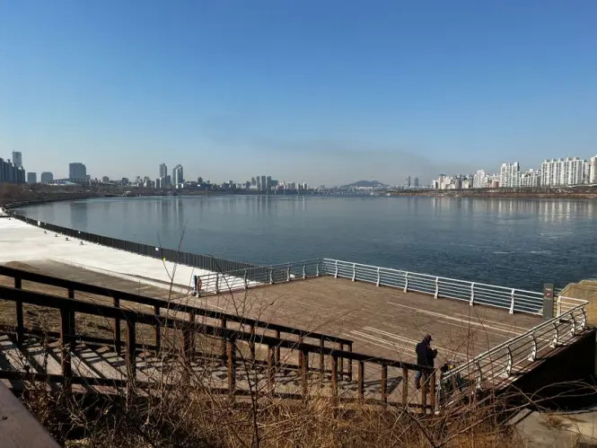 Cyclist riding along the Han River bike path near Seoul Forest
