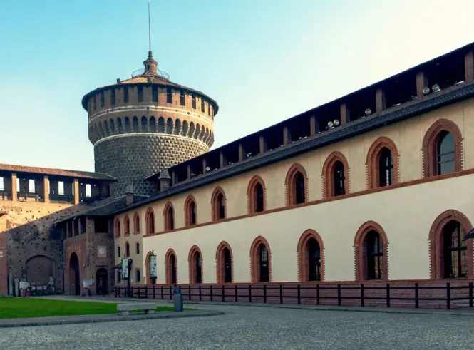 Visitors line up near the brick walls of the Sforza Castle courtyard