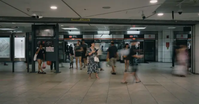 Modern public transport MRT station entrance in Singapore with passengers