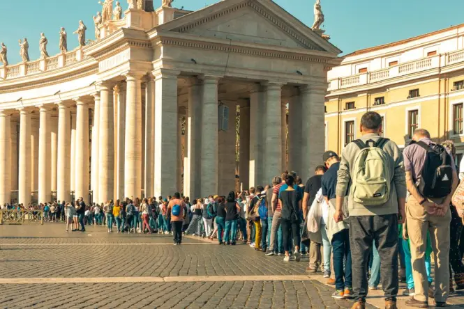 Visitors queuing for security screening before entering St. Peter's Basilica