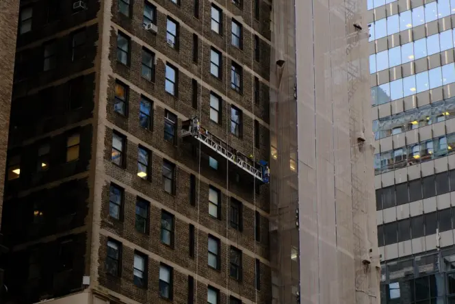Transparent glass elevator on a New York skyscraper facade