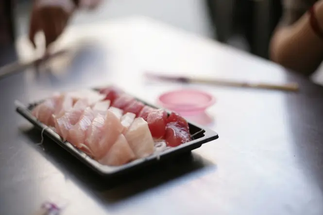Fresh sashimi tray with tuna and salmon at a Sydney Fish Market counter
