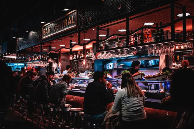 Evening crowd under lights at a Lisbon food hall