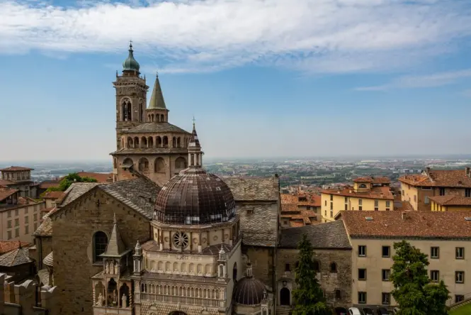 The brick bell tower designed by Filippo Juvarra adjacent to the white marble Turin Cathedral.