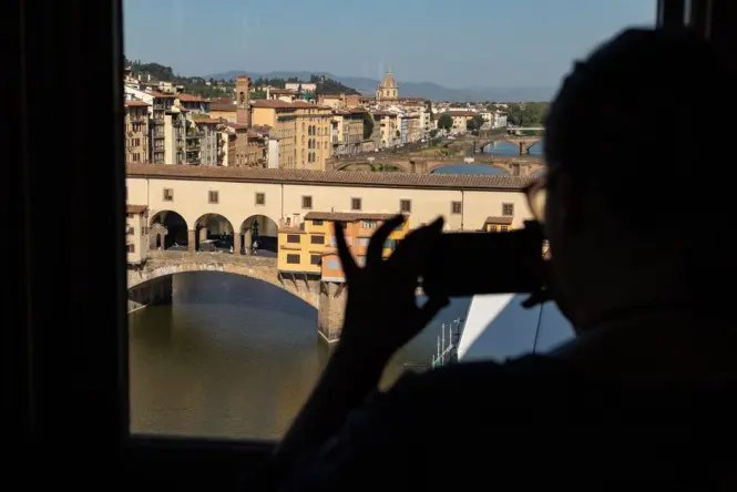 View of the Ponte Vecchio bridge across the Arno River from the Uffizi Gallery window