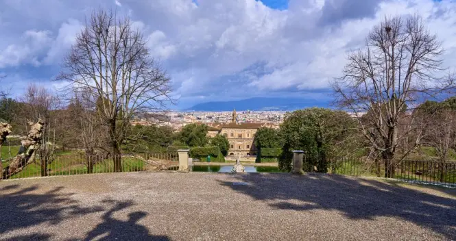 The grand stone facade of the Pitti Palace in Florence