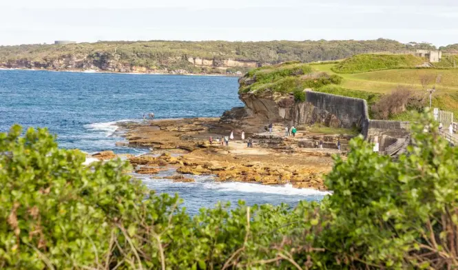 Visitors walking along the fenced clifftop path at The Gap
